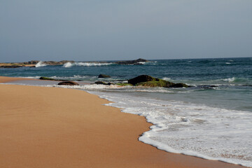 Wave coming to the sand beach.