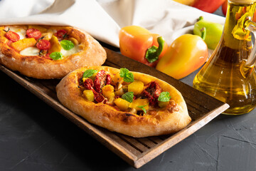A pie with vegetables on a dark background. Breakfast is an appetizer.