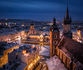 Panorama of Old Town (Main Square, Saint Mary's Basilica, Sukiennice - Town Hall, Town Hall Tower) in Krakow during magic dawn in winter, Poland