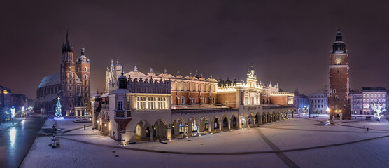 Panorama of Main Square (Saint Mary's Basilica, Sukiennice - Town Hall, Town Hall Tower) in Krakow at night in winter, Poland