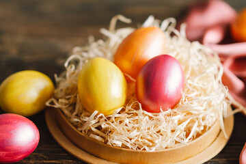 Obraz na płótnie Canvas Multicolored Easter eggs on a wooden background. Easter background. Copy space. Easter eggs flat lay on rustic table. Easter concepts