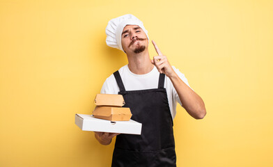 young chef with moustache with take away fast food