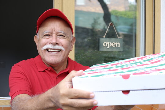 Senior pizza delivery man with red uniform