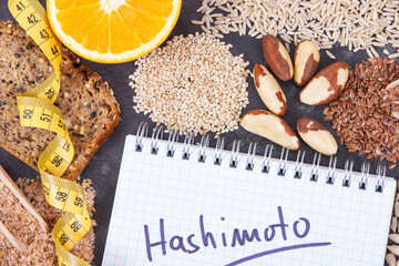 Tape measure, notepad with inscription hashimoto and best ingredients for healthy thyroid. Dieting and slimming concept