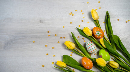 easter eggs and tulips on wooden background