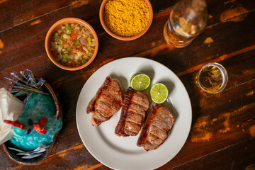 Delicious Food Contemporary Classic Dish Plate Menu Lunch Dinner Chicken BBQ Pork Sausage Bacon Regional Native Dessert on a WoodenTable