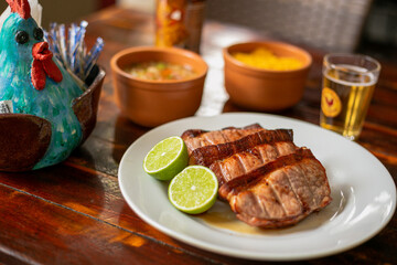 Delicious Food Contemporary Classic Dish Plate Menu Lunch Dinner Chicken BBQ Pork Sausage Bacon Regional Native Dessert on a WoodenTable