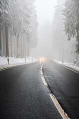 Fototapeta premium car driving on winter mountain road