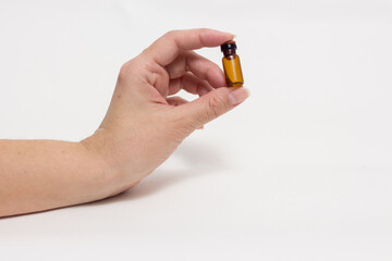 Small medicine bottle in hand. Homeopathy.