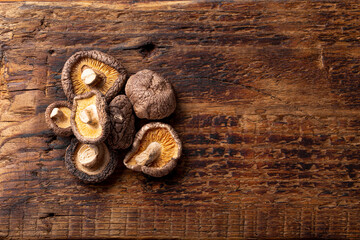 Dried shiitake mushrooms on a wooden background top view copy space for text