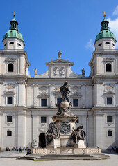 Fototapeta na wymiar The Marien Statue with the Virgin Mary standing on top in front of Salzburg Cathedral.