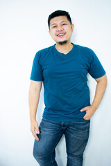 Asian young man wearing a dark green shirt smiling and looking at the camera in the white background