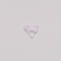 Heart symbol made of beauty cream on white background. Minimalist beauty branding concept. Valentine's Day, Woman Day composition