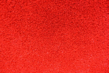 Artificial red grass carpet texture