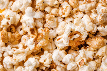 Closeup popcorn abstract background on yellow. Copy space
