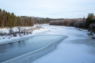 Winter scene at the frozen river Gauja in January in Latvia