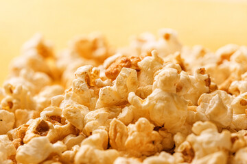 Closeup popcorn abstract background on yellow. Copy space