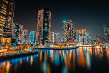 Obraz na płótnie Canvas Fantastic nighttime skyline with illuminated skyscrapers. Dubai, UAE