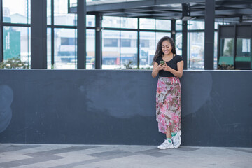 Young woman in the city calling by phone.