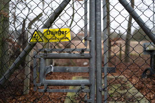 Generic Danger Sign seen attached to a remote power generation transformer. The sign warns of buried HV cables.