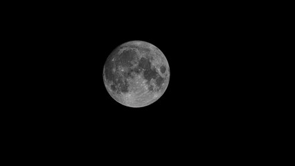 Full Earth's Moon glow on black background. Image in high resolution. Bright lunar satellite