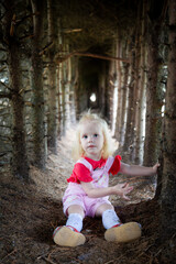 the girl is sitting in the forest