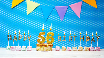 Congratulations on your birthday from the letters of the candles number 56 on a blue background...