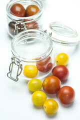 Two glass jars with cherry tomatoes 