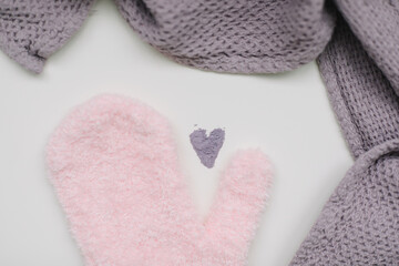 Minimal flat lay composition of massage mitten washcloth and a heart made of violet powder on a white background. Concept of zero waste