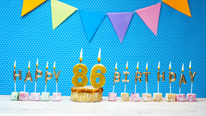 Happy birthday from candle letter number 86 on blue background with white polka dot copy space....