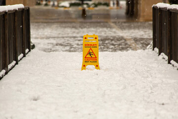 A sign warning of slippery ground on snow