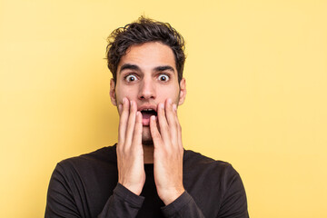 young handsome surprised or shocked hispanic man
