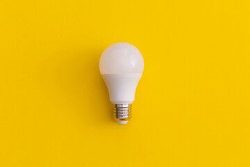 Light bulb on yellow background. Inspiration and creative idea concept.