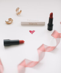  Concept Women's Day, Valentines Day, March 8. Lipsticks, cosmetic makeup products and accessories flatlay top view. 