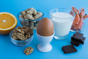 Close-up on food allergens on the blue background. Copy space. Food allergy concept.