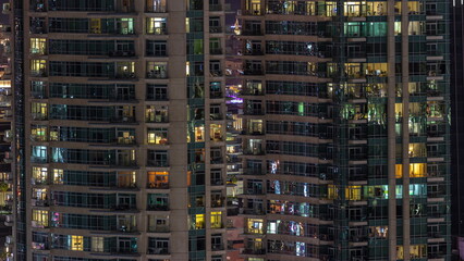Fototapeta na wymiar Night view of glowing windows in apartment building timelapse.