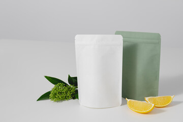 Сardboards packaging for tea, flowers and lemons on a white background. Blank tea packaging mockup with tea to demonstrate your branding design.