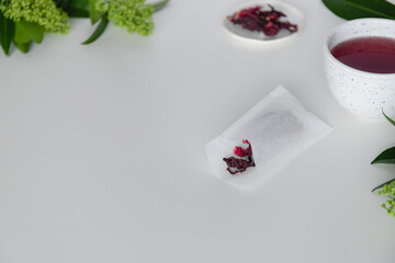 Hibiscus tea, tea bags with dry leaves hibiscus on white background