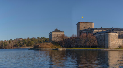 Fototapeta na wymiar Northern part of the 1700s defense line fortress Vaxholms kastell and the redoubt on the island Rindö a sunny winter day in the archipelago of Stockholm