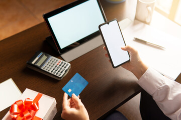 Fototapeta na wymiar Woman using smartphone with credit card, ordering online shopping. Working from home concept