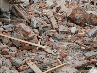 Ruins of a brick building. Old bricks, planks, destroyed concrete. - 482900251