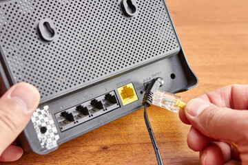 A man connects a router to the Wi-Fi Internet
