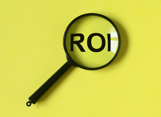 ROI through magnifying glass. Return of investment.