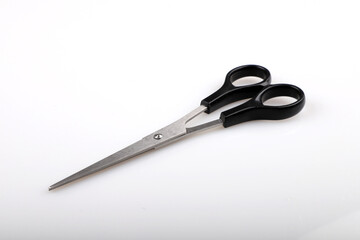 Black handle scissors on white background.