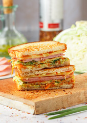 Korean sandwich made from bread, eggs, cabbage, onions, carrots, with ketchup, mayonnaise, sugar and cheese.  Gilgeori Street Toast close-up. Selective focus