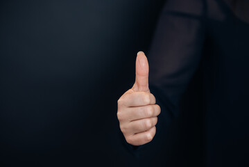 Thumbs up isolated on black background