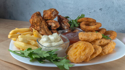 Snack platter - cheese sticks, chicken nugget, onion rings, french fries mix of snacks and sauces ....