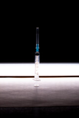 one 3 ml syringe under horizontal backlight