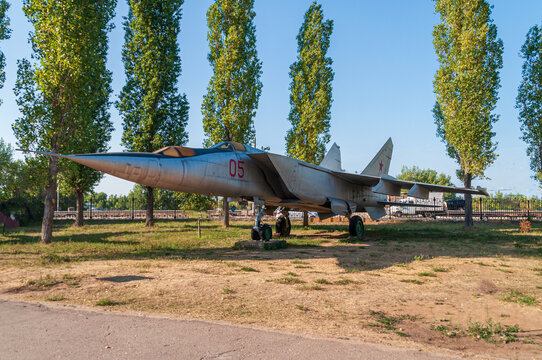 Training aircraft MIG 25 pu. Supersonic fighter installed in the victory park in Nizhny Novgorod. Standing on the ground against the backdrop of green trees and blue sky. High quality photo