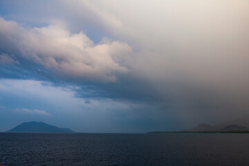 A tropical storm drops rain over the ocean and islands in Indonesia. 